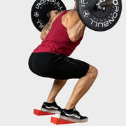 Weight lifter using squat wedges to better his technique during back squat